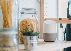 smarthome device on kitchen shelf next to pasta and houses plant